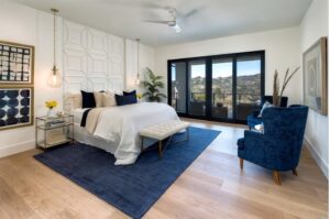 a bedroom with a blue rug and a bed